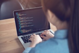 woman coding on laptop