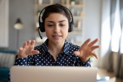 young woman on laptop with headset