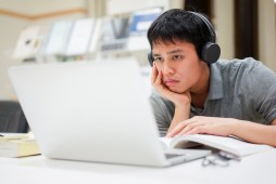 college student frowning at laptop