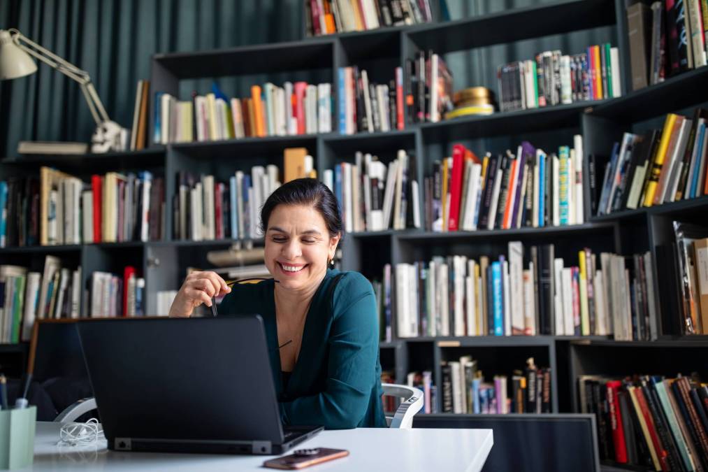 woman laughing at laptop