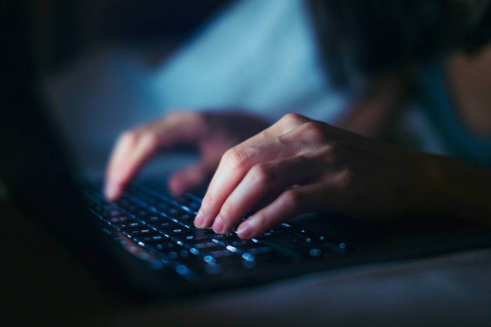 hands typing on keyboard