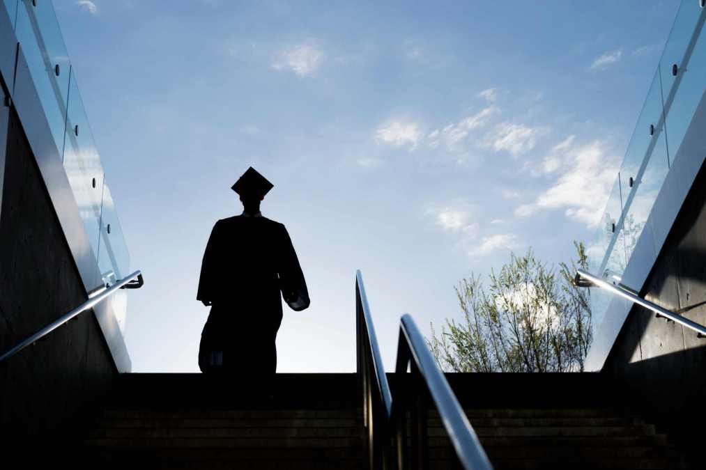 Silhouette of College Graduate Climbing Steps