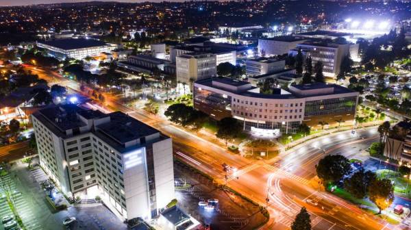 An aerial photograph of the California State University Fullerton campus at night.