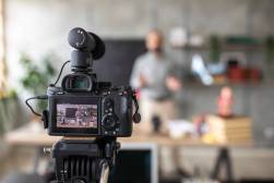 DSLR camera on tripod, recording a video of teacher during e-learning class during covid-19 pandemic