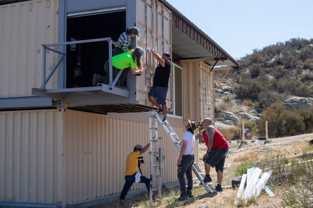 Boot camp participants set up a point-to-point unit on a garage.