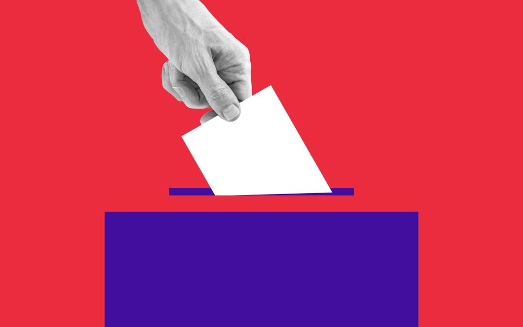 hand putting ballot in box